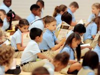 00023955A ma nb AlmadelMar1stDay  K-4th grader students read a book before morning routines in the gym on their first day of school at the Alma del Mar's new school on Belleville Avenue in the north end of New Bedford.   PETER PEREIRA/THE STANDARD-TIMES/SCMG : school, education
